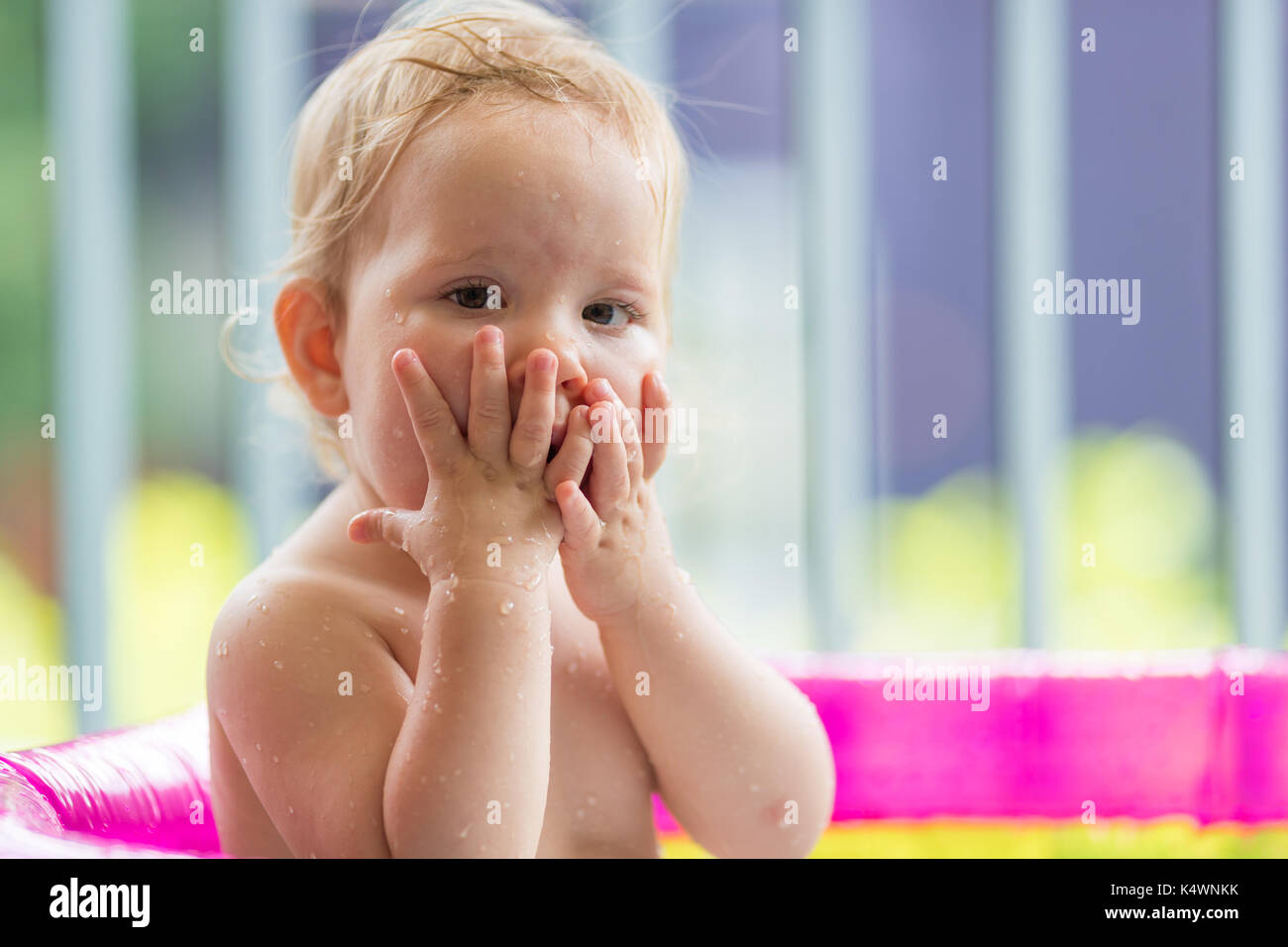 18 months old baby girl playing in inflatable pool Stock Photo Alamy