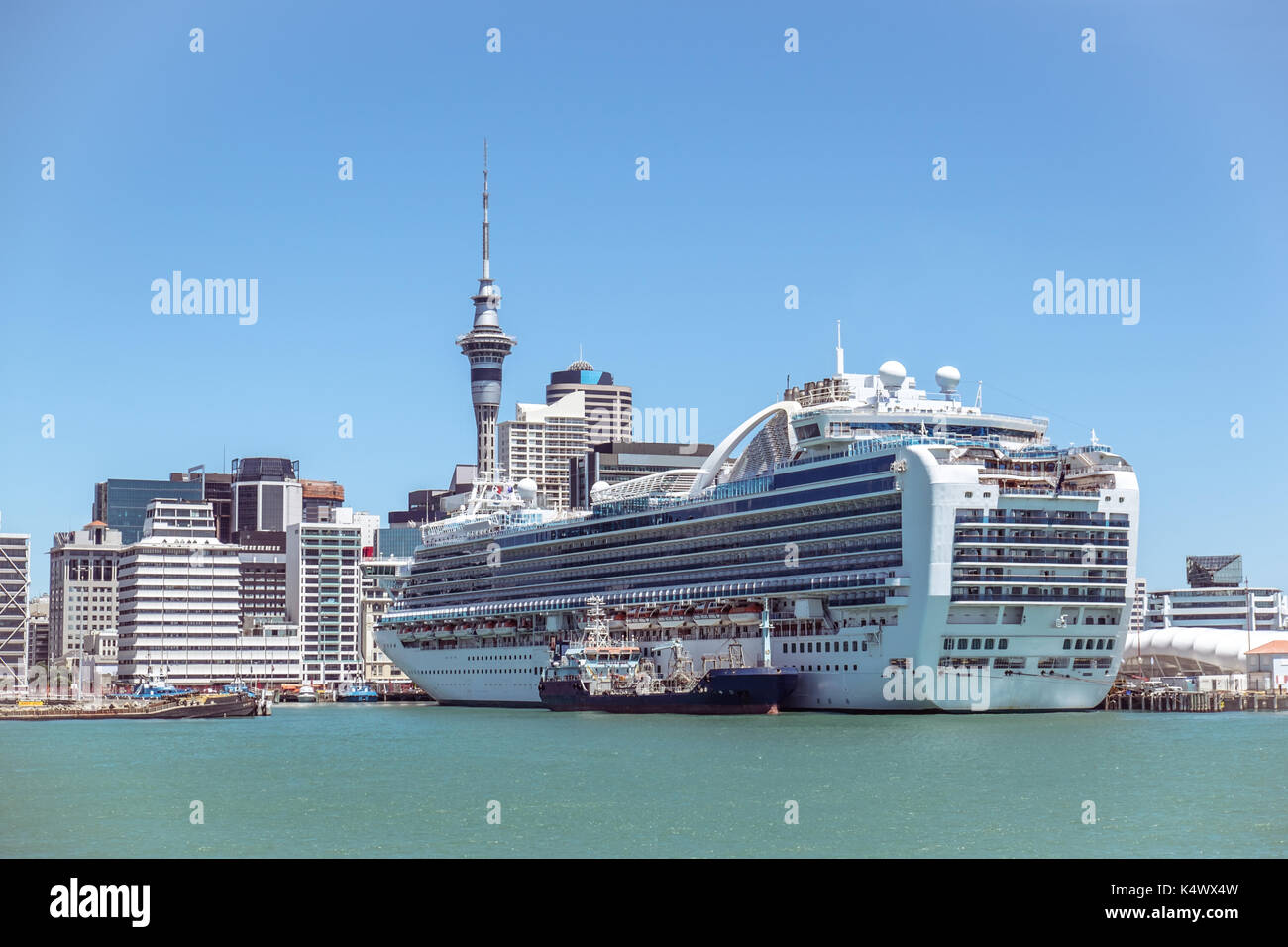 Auckland CBD city centre skyscrapers and Sky Tower with a cruise ship in New Zealand, NZ Stock Photo