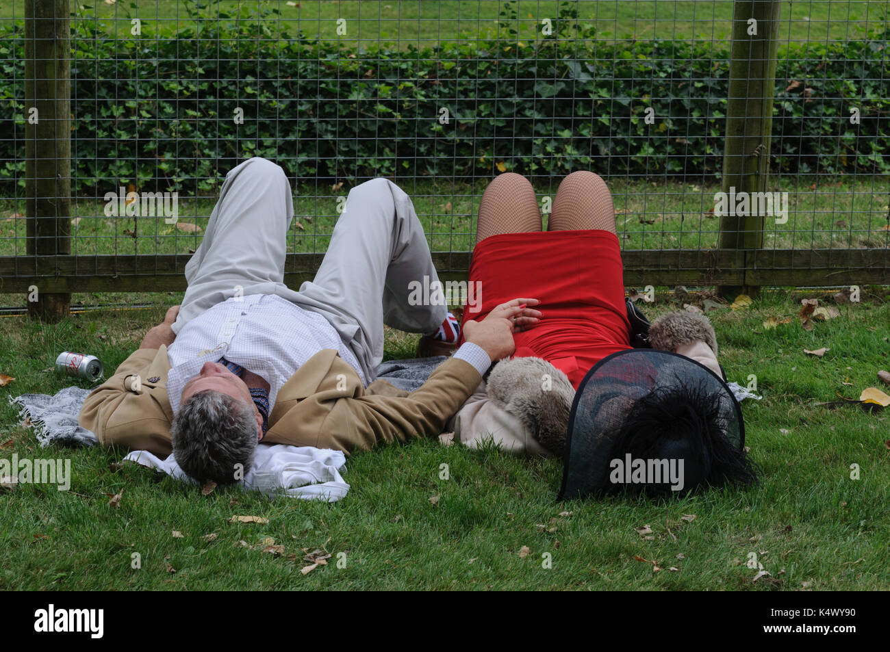 Two Spectators in Period dress Relaxing at Goodwood Revival Stock Photo