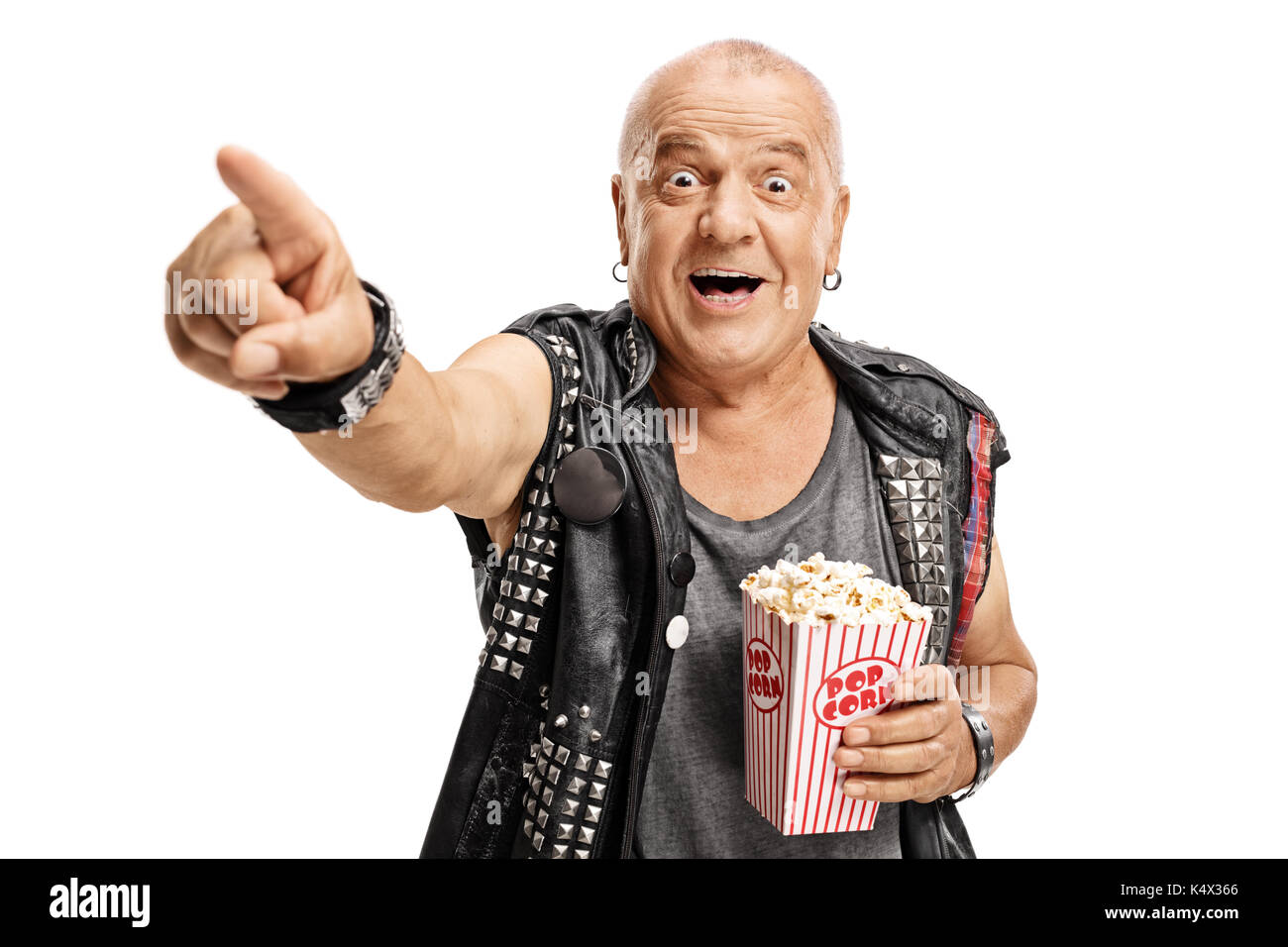 Elderly punker with a popcorn box pointing and laughing isolated on white background Stock Photo