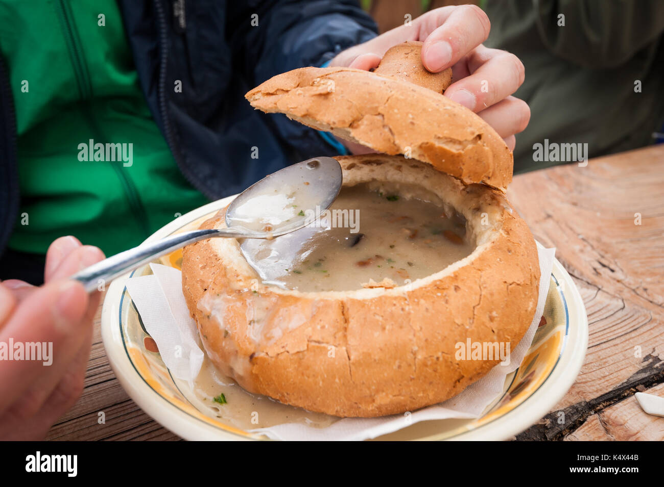 Creamy wild mushroom soup served in a bowl of bread. Typical mountain dish. Stock Photo