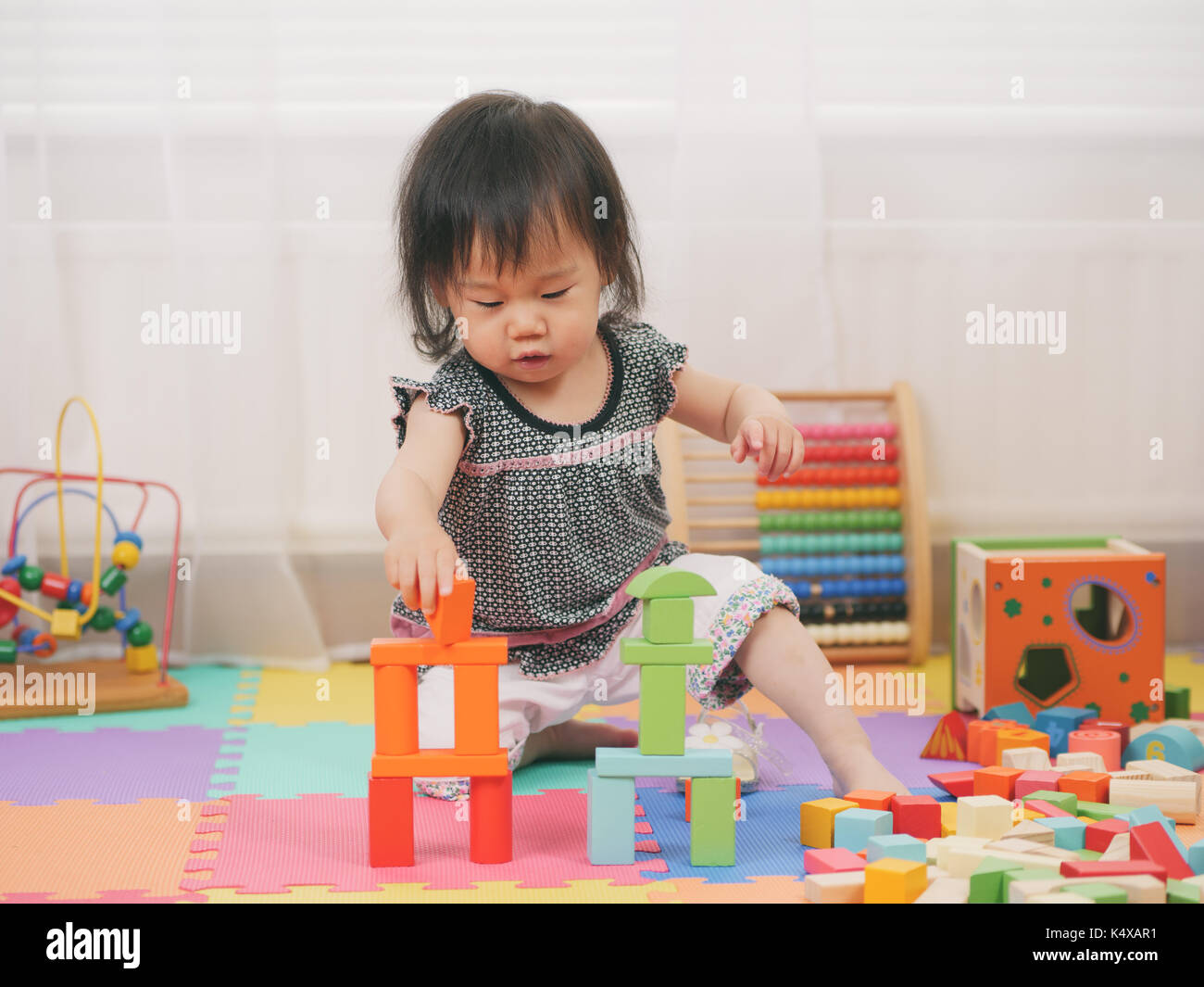 baby girl playing toy at home Stock Photo