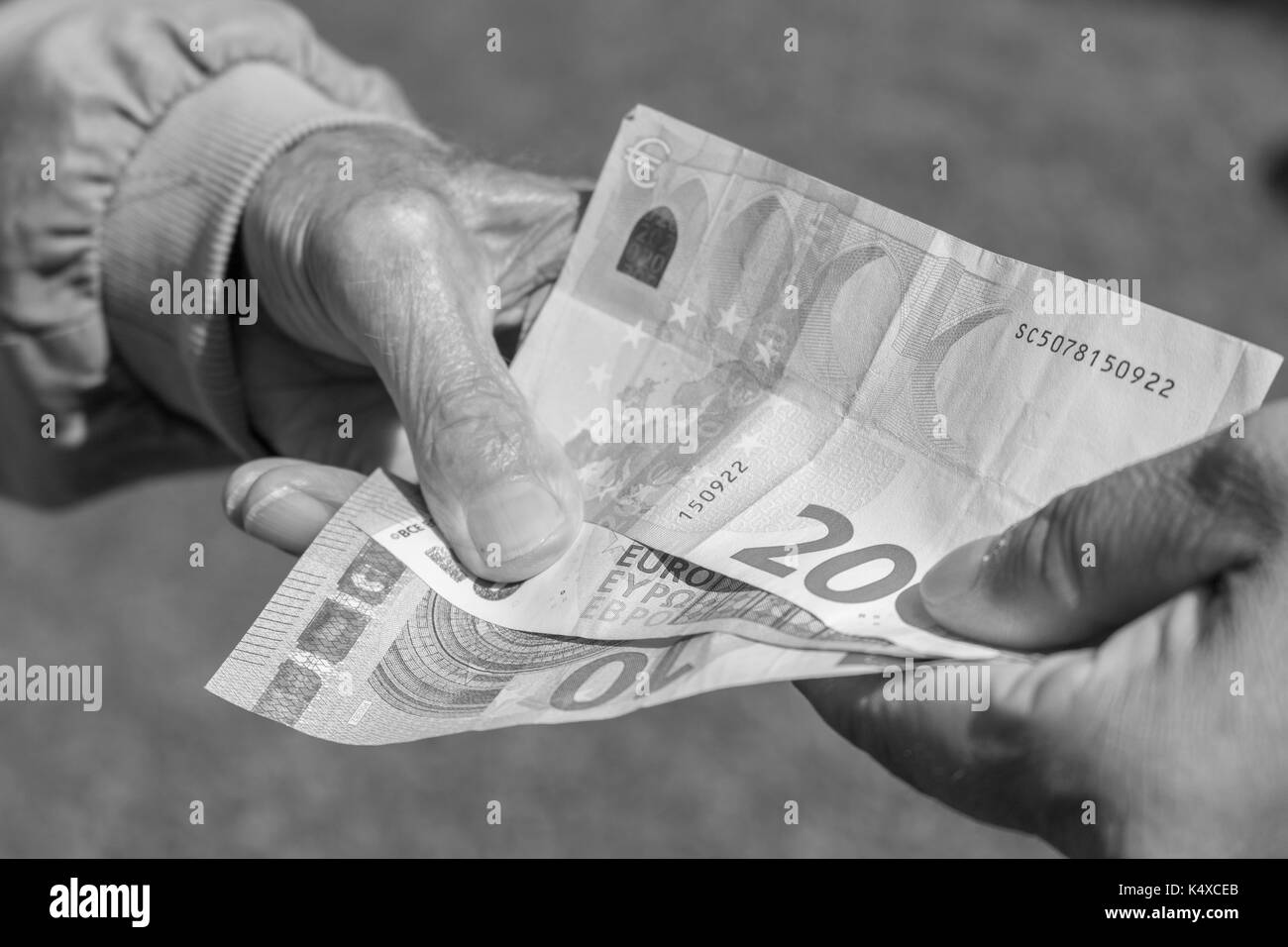 Senior man's hands holding Euro banknote.  pensioners concept. Stock Photo