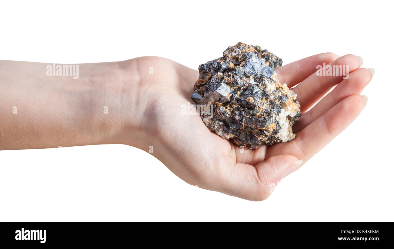 side view of zinc and lead mineral ore (sphalerite with galena) on female palm isolated on white background Stock Photo