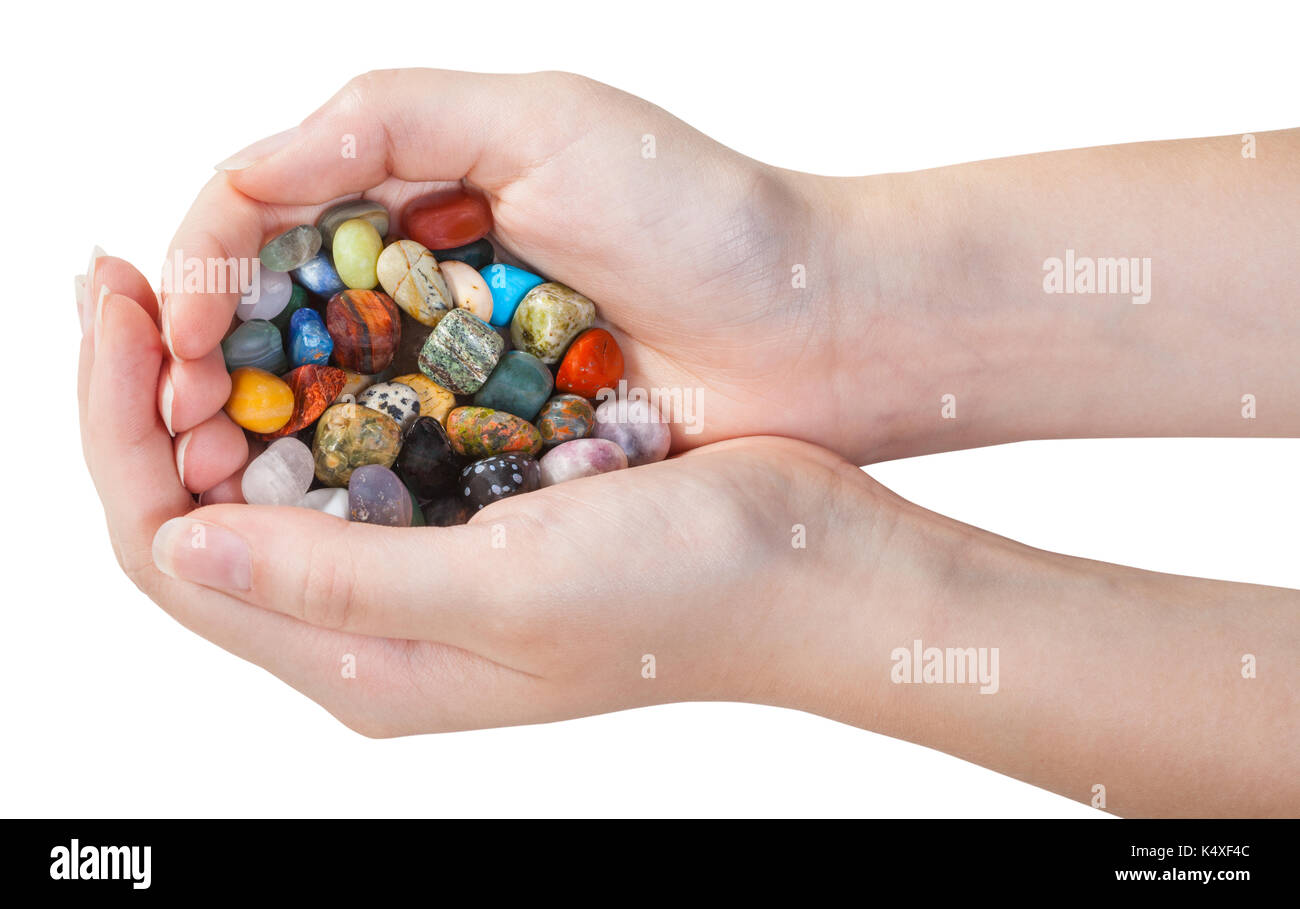 many various gemstones in handful isolated on white background Stock Photo