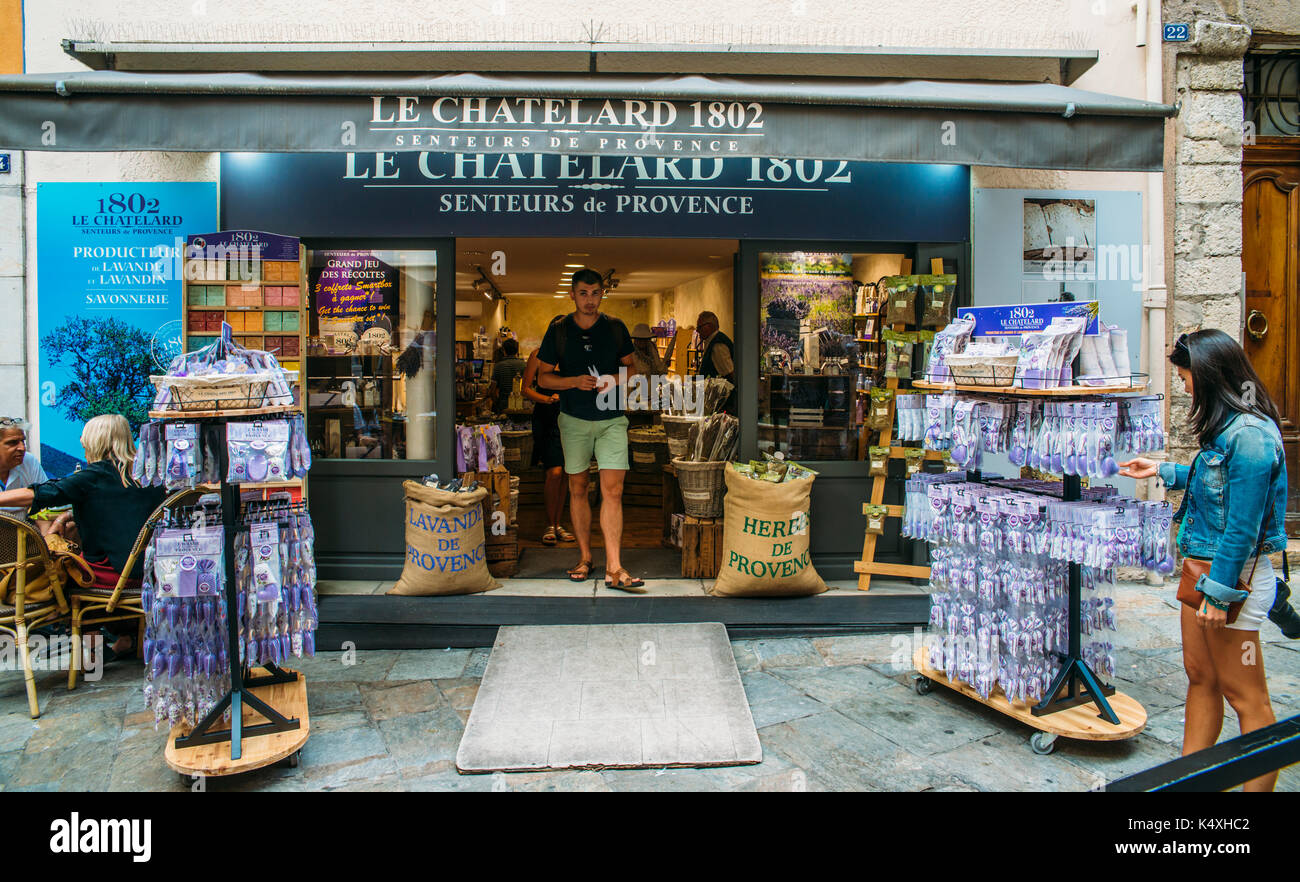 Attractive brunette woman (30-35) smelling lavender for sale in Grasse, Cote d'Azur, France. The city is famous for its perfumes Stock Photo