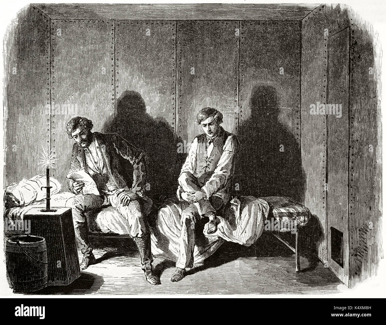Two ancient people elegant dressed jailed in a dark, claustrophobic prison cell. John Doy and his son Charles imprisoned. By Janet-Lange published on Le Tour du Monde Paris 1862 Stock Photo