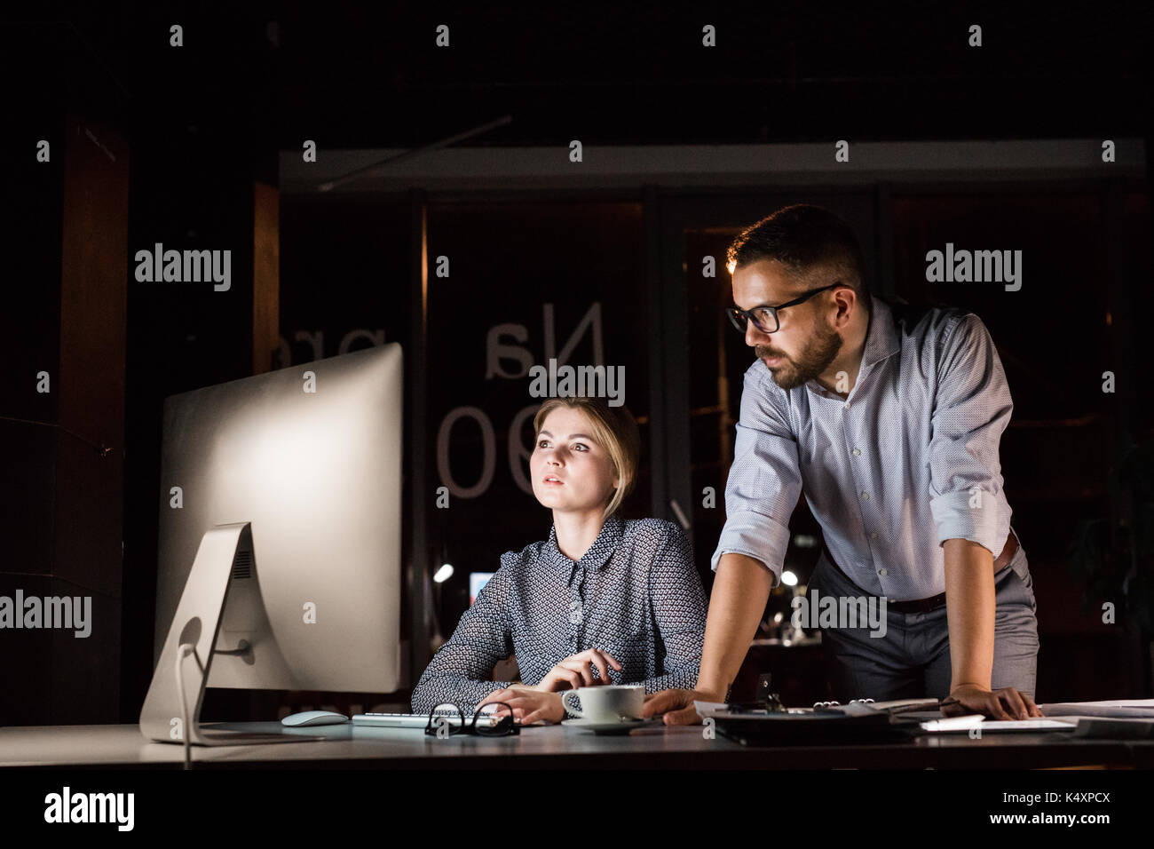 Businesspeople in the office at night working late Stock Photo - Alamy