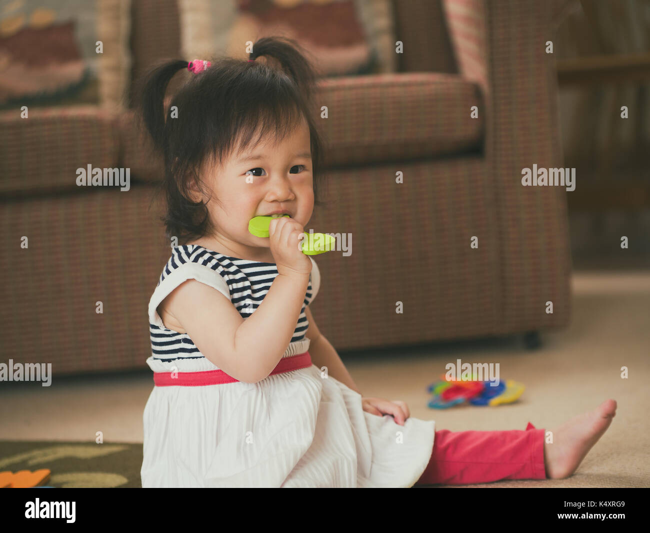 baby girl playing toy at home Stock Photo - Alamy