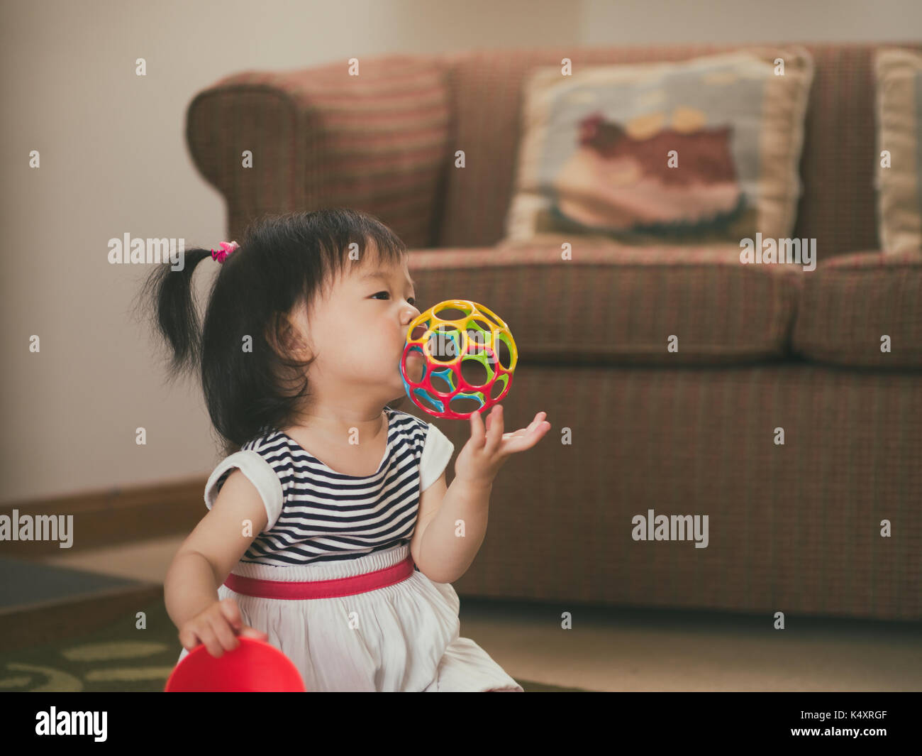 baby girl playing toy at home Stock Photo - Alamy