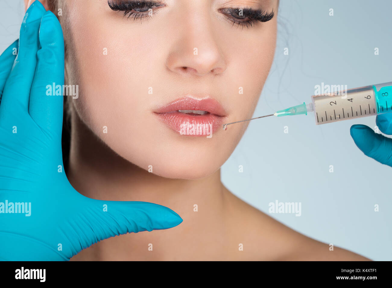Cropped portrait of pretty woman getting lips injection Stock Photo - Alamy