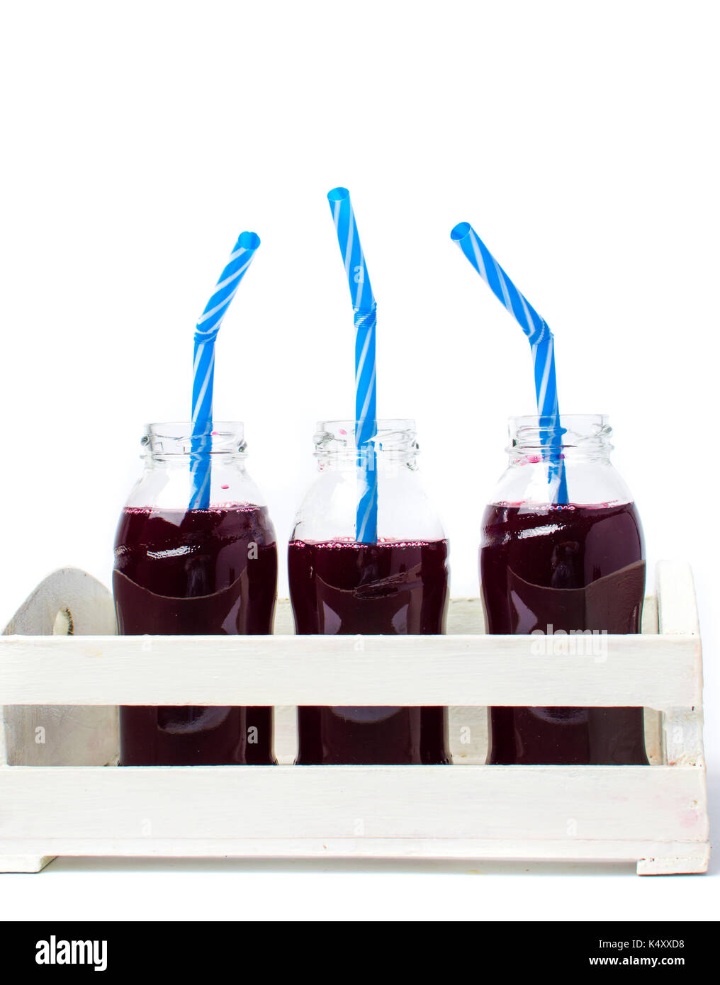 Blueberry juice bottles in a white wooden box isolated Stock Photo Alamy