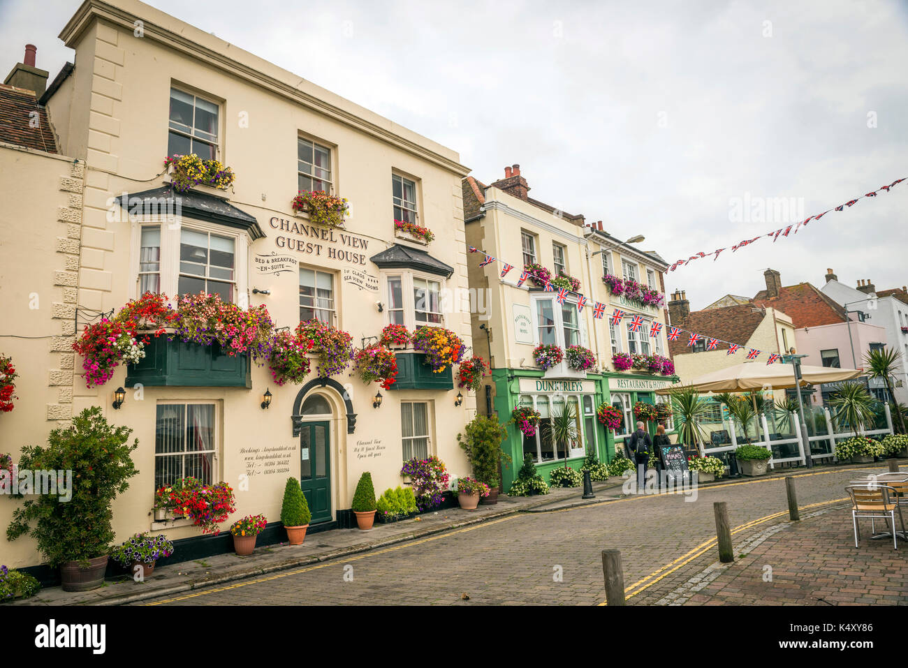 Seafront buildings decorated with hanging flower baskets in Deal, Kent, UK Stock Photo