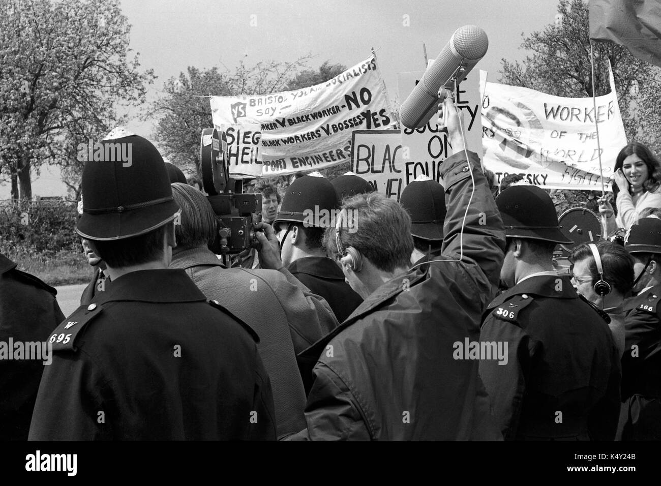 Enoch Powell protest: A  BBC news crew films as police push back anti-racism students from Bristol University demonstrating against Enoch Powell MP three weeks after his controversial speech on immigration that became known was the “rivers of blood” speech.  The picket was at a public meeting in Chippenham in Wiltshire on 11 May 1968.  It was the early days of BBC colour and the crew flew in and out by helicopter. Stock Photo