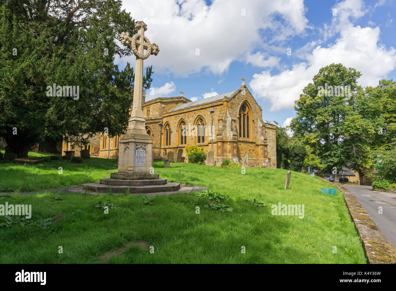 The church of St Mary The Virgin with the war memorial to the front, Dallington Village, Northampton, UK Stock Photo