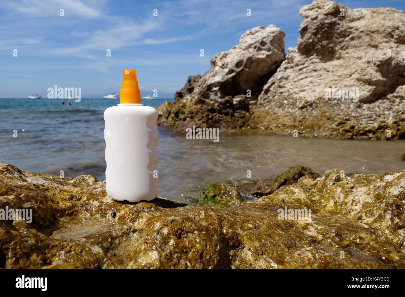 Sun cream bottle in front of the sea, in the beach Stock Photo