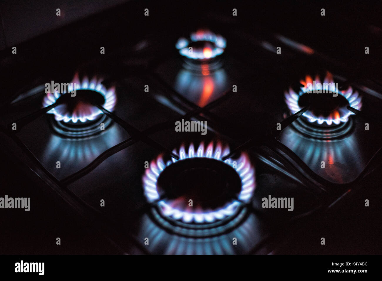 Rings of fire four lighted gas stove burners Stock Photo Alamy
