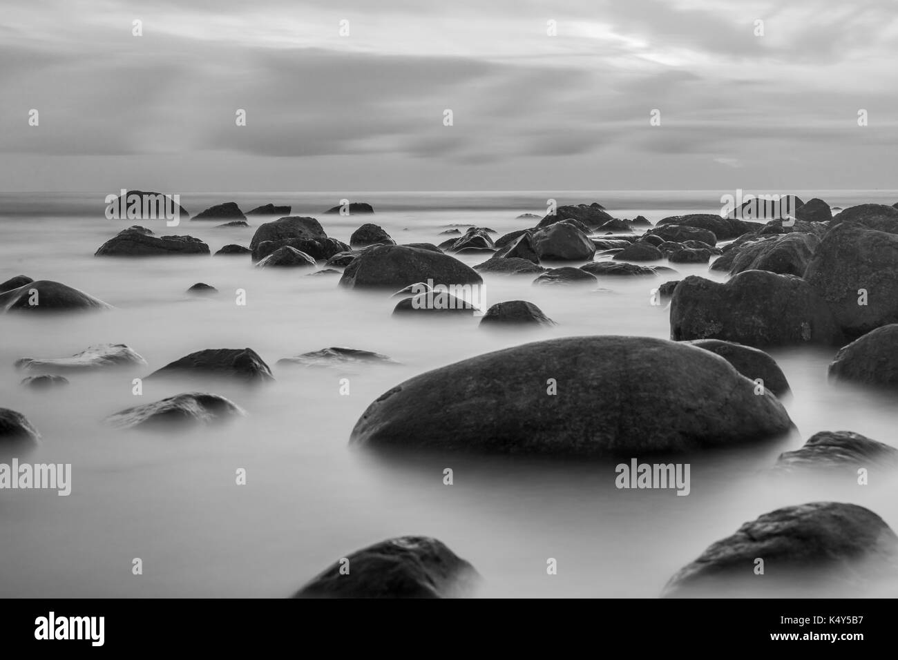 Beautiful seascape background, rocks in the Irish Sea at Seascale beach near Sellafield, Cumbria, England, United Kingdom Stock Photo