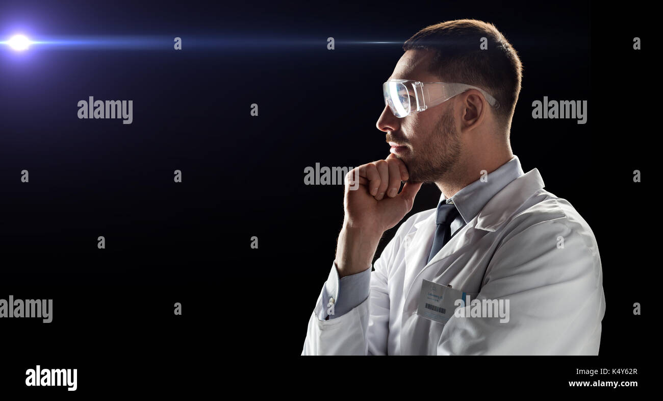 doctor or scientist in lab coat and safety glasses Stock Photo Alamy