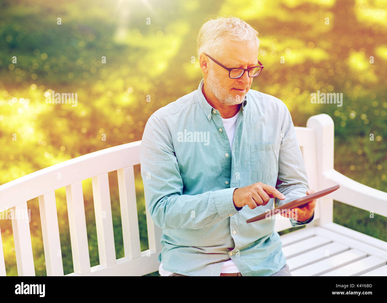 senior man with tablet pc at summer park Stock Photo