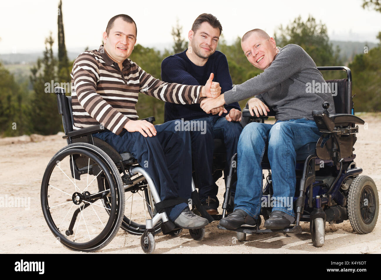 Disabled happy friends  with thumbs up. Stock Photo