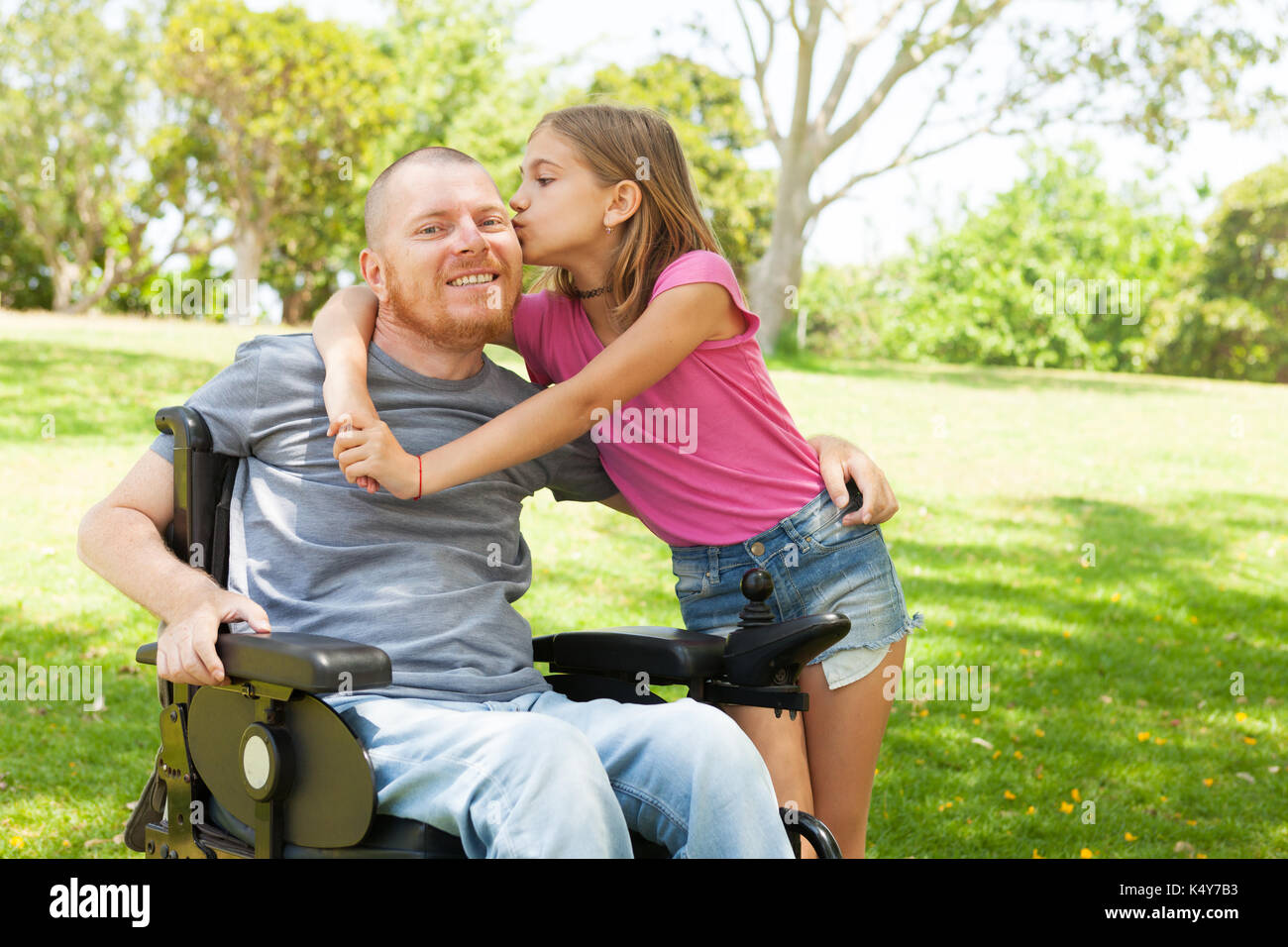 Disabled father with his little daughter. Stock Photo
