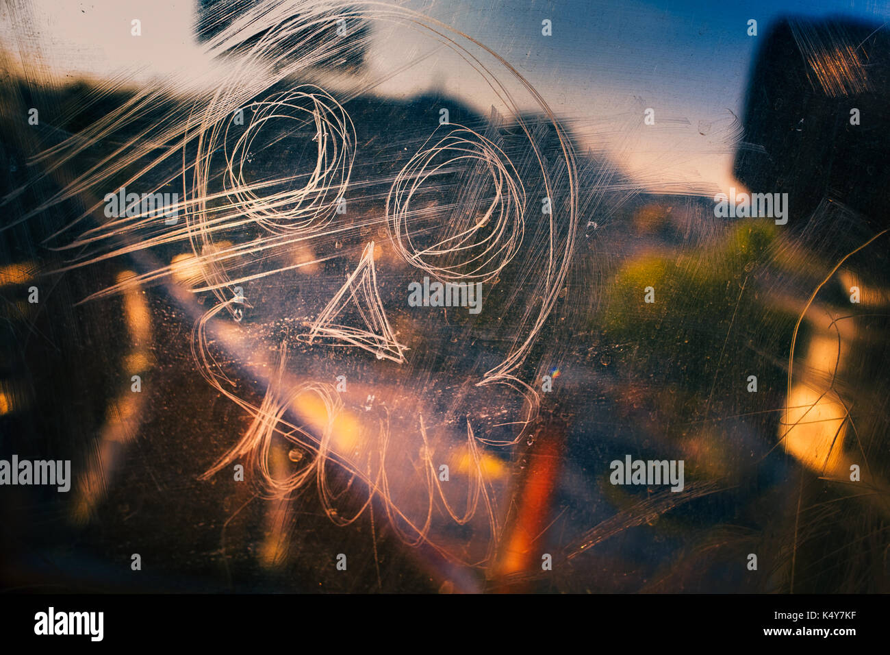 A skull tag is seen scratched into the glass window of a subway car passing in the outskitrs of Mexico City, Mexico, 1 November 2016. Stock Photo