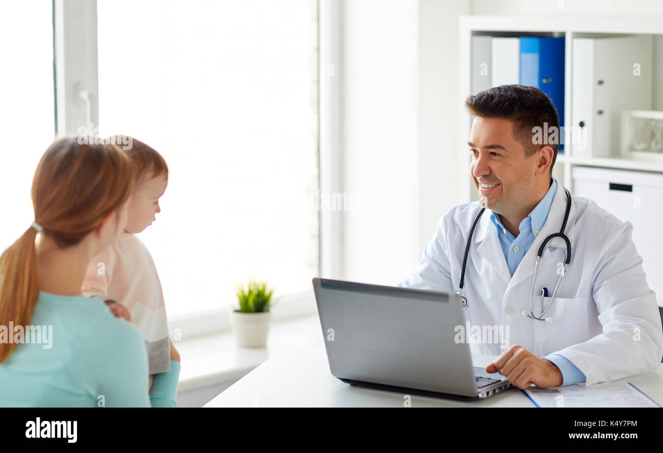 woman with baby and doctor with laptop at clinic Stock Photo - Alamy