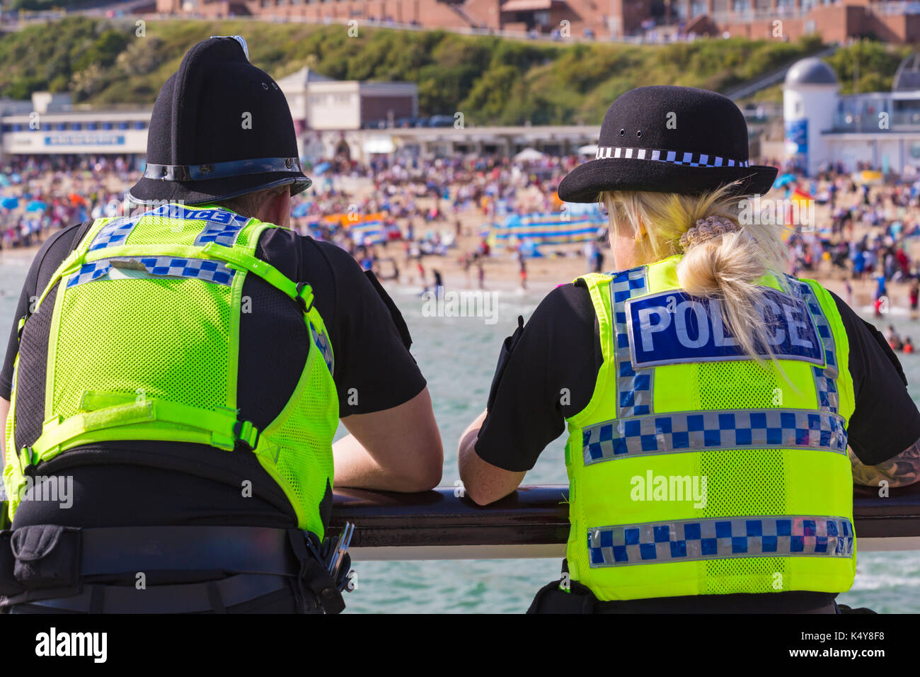 Police, policeman and policewoman, on duty on Bournemouth Pier during Bournemouth Air Festival at Bournemouth, Dorset UK in September Stock Photo