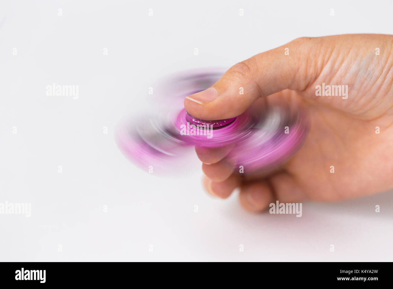 close up of hand playing with fidget spinner Stock Photo