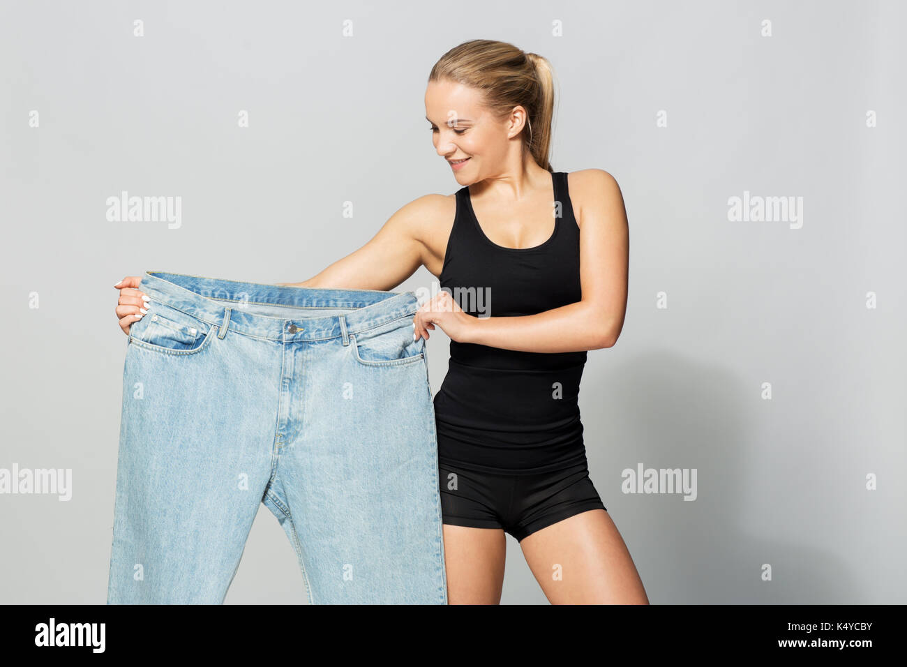 young slim sporty woman with oversize pants Stock Photo