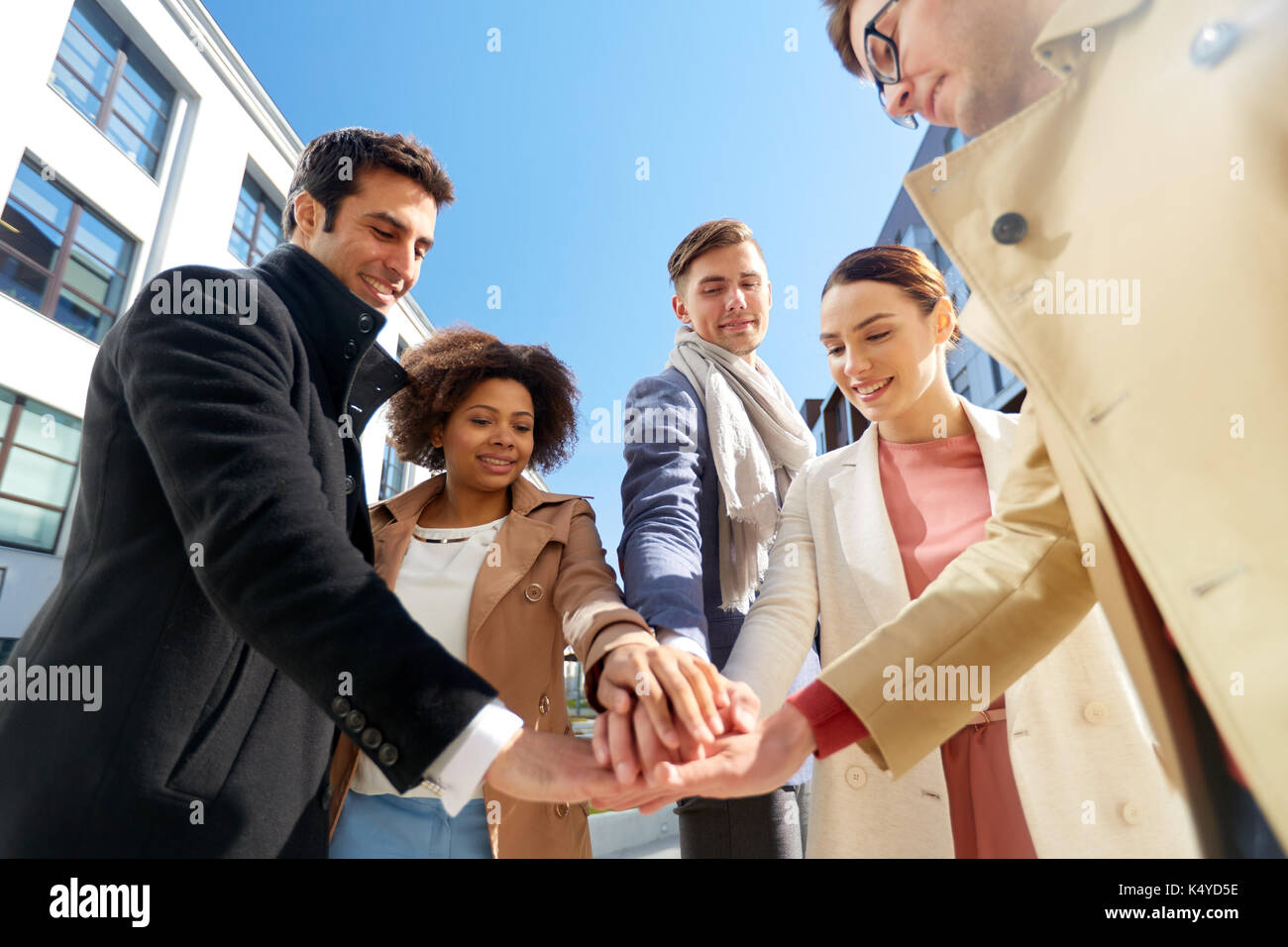 group of happy people holding hands in city Stock Photo - Alamy