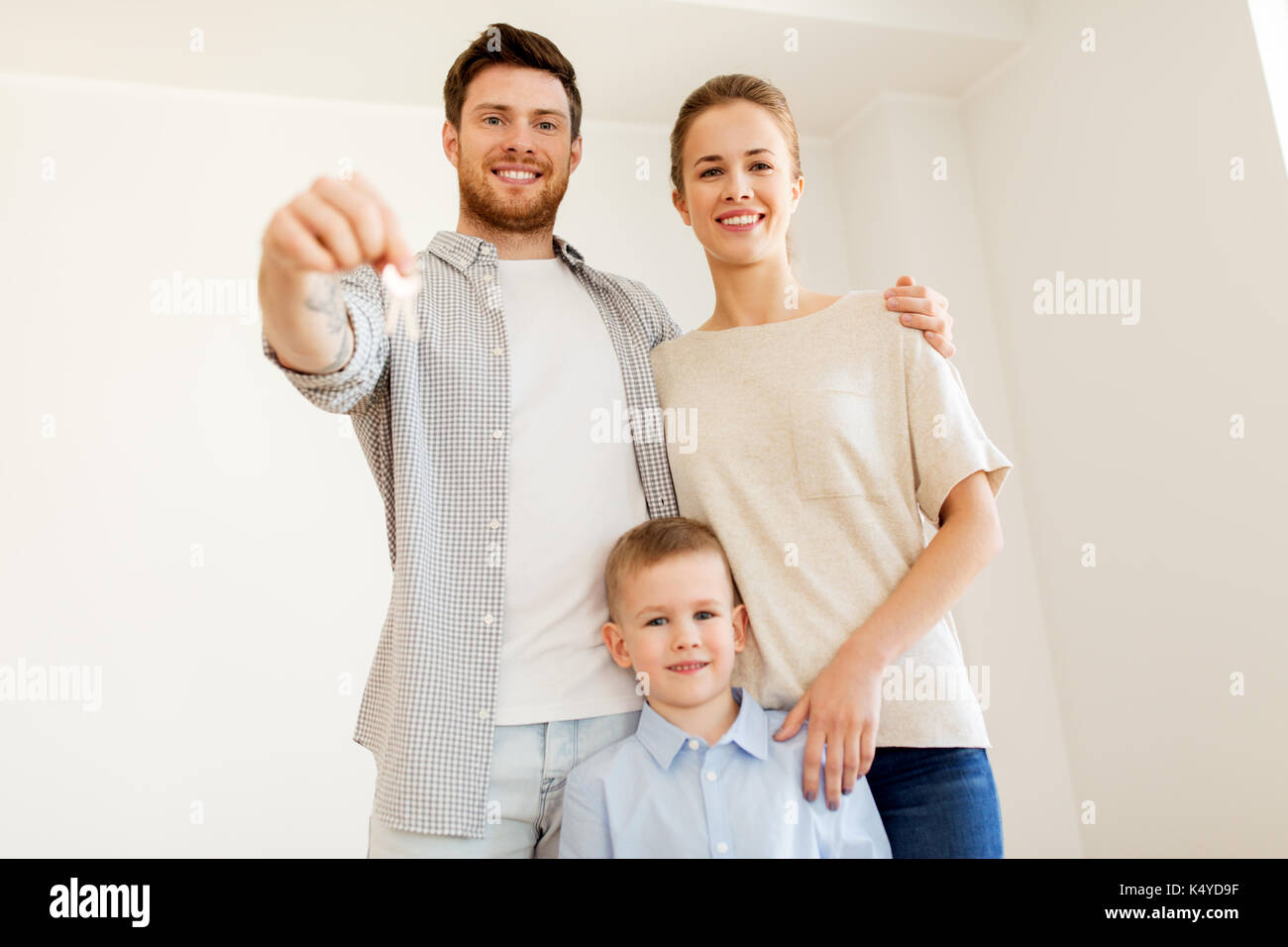 happy family with key moving to new home Stock Photo - Alamy