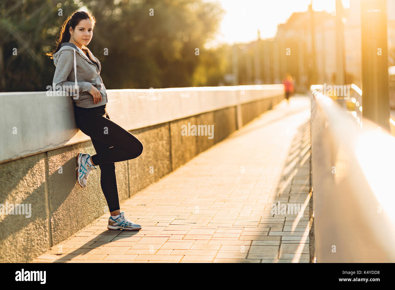 Sportswoman resting after jogging Stock Photo