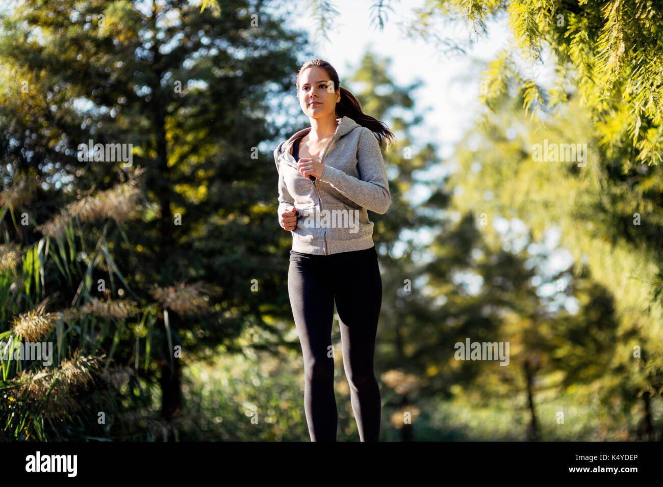 Beautiful woman jogging in nature Stock Photo