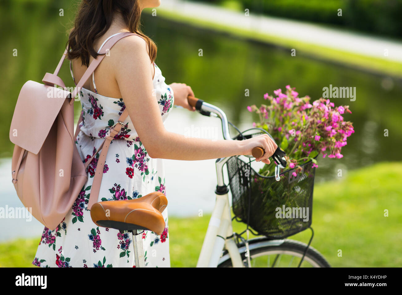 close up of woman with fixie bicycle in park Stock Photo