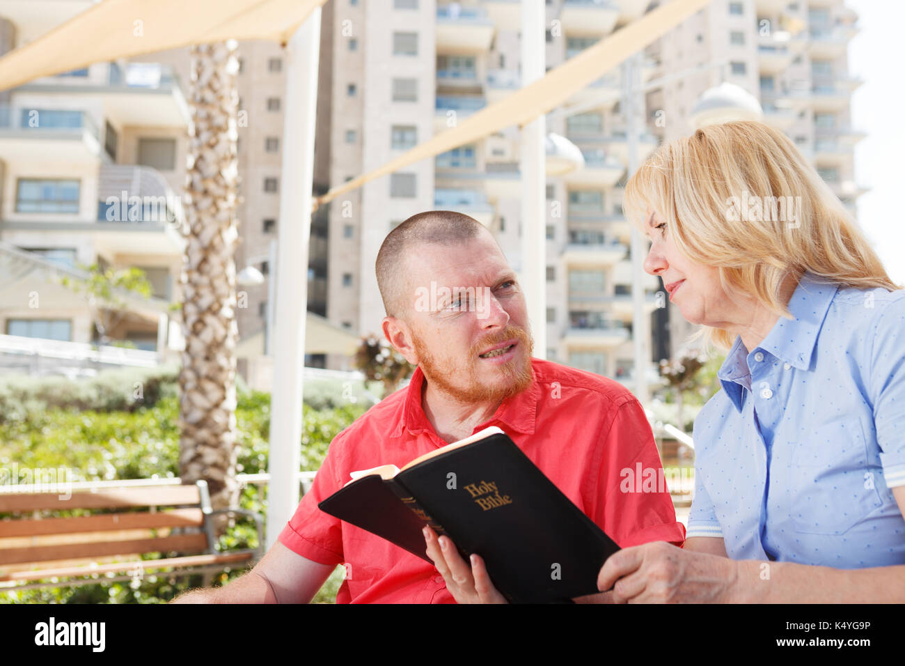 We studying Holy Bible together. Disabled man. Stock Photo