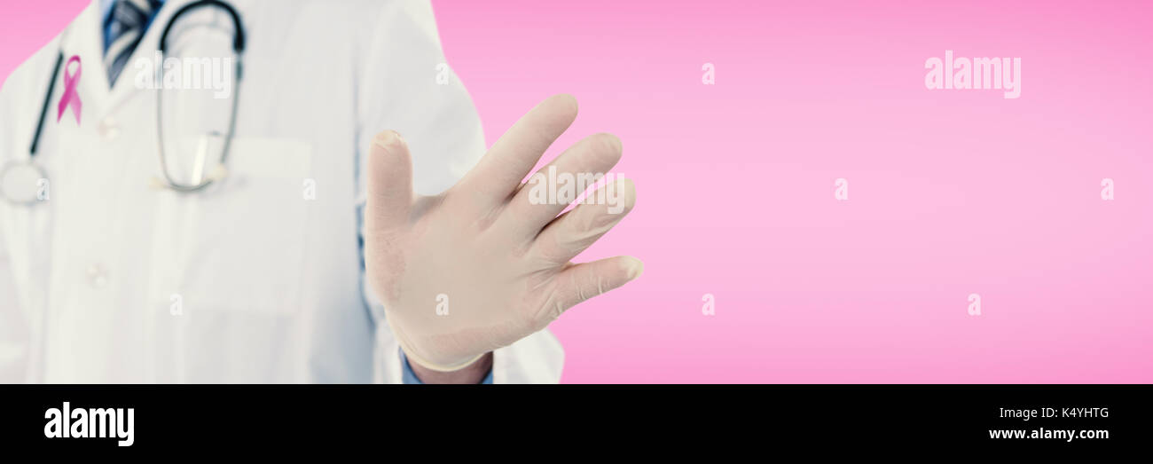 Doctor touching an digital screen  against pink Stock Photo