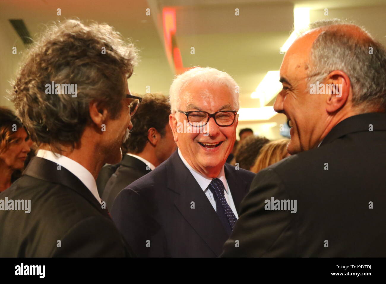 ITALY, Venice: Paolo Baratta, President of la Biennale di Venezia speaks with Director Silvio Soldini (L) and Director of the Venice International Film Festival Alberto Barbera (R) at the Premiere of the movie 'Il colore nascosto delle cose' during the 74th Venice International Film Festival at Lido of Venice on 7th September, 2017. Stock Photo