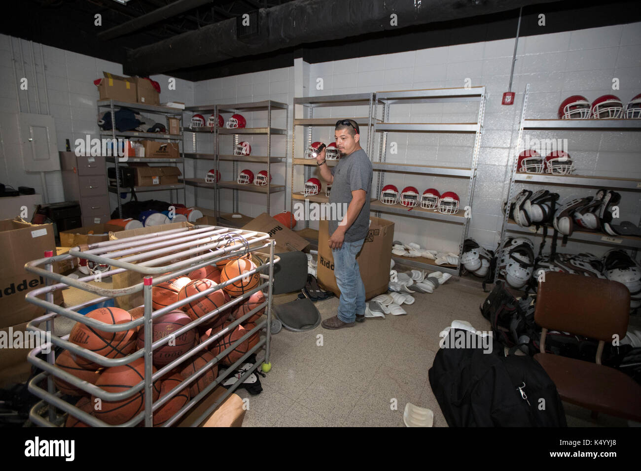 Sour Lake, USA. 07th Sep, 2017. Sour Lake, Texas USA Sept. 7, 2017: Jesse Castillo of RestoreAll in Atlanta works in the Sour Lake Middle School gymnasium that was innundated with floodwaters almost two weeks ago from Hurricane Harvey. Credit: Bob Daemmrich/Alamy Live News Stock Photo