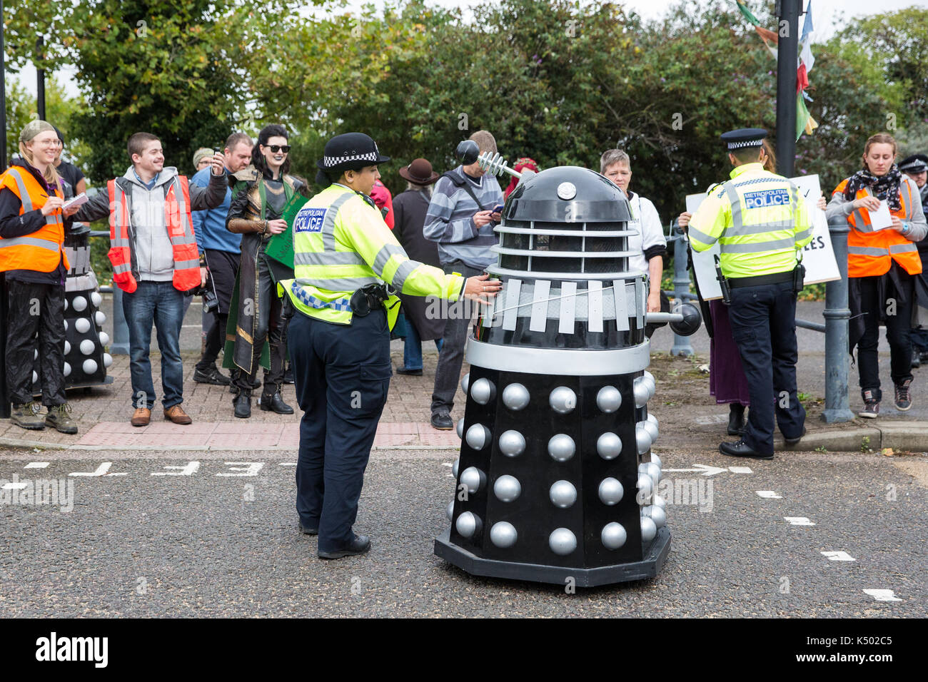 London, UK. 8th Sep, 2017. A police officer asks a Dalek to clear the road during a protest by super villains against the DSEI arms fair to be held at the ExCel Centre next week. DSEI is one of the world's largest arms fairs and military delegations from states believed to be responsible for widespread abuses of human rights are expected to attend. Credit: Mark Kerrison/Alamy Live News Stock Photo