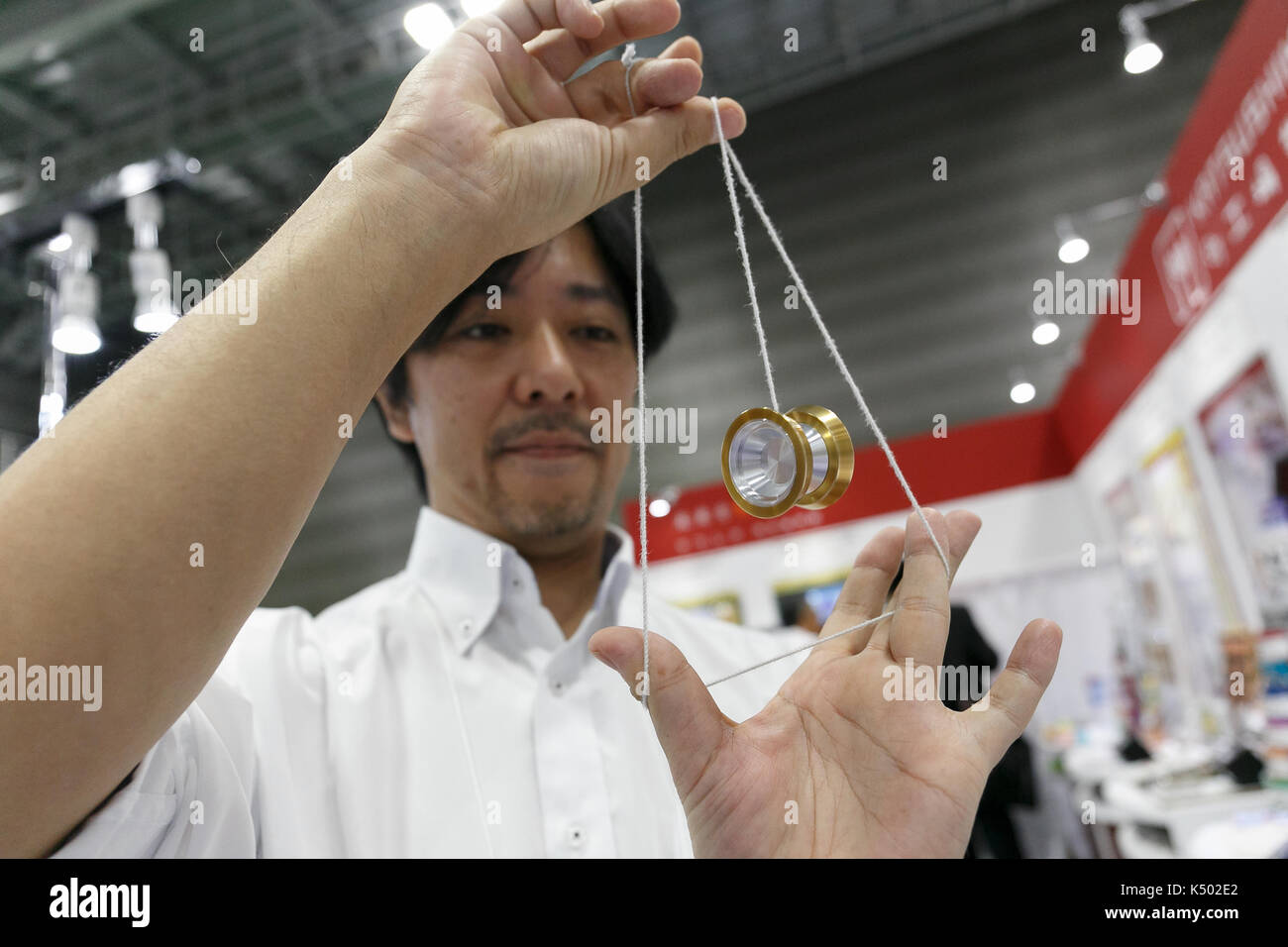An exhibitor demonstrates various yoyo tricks during the Tokyo
