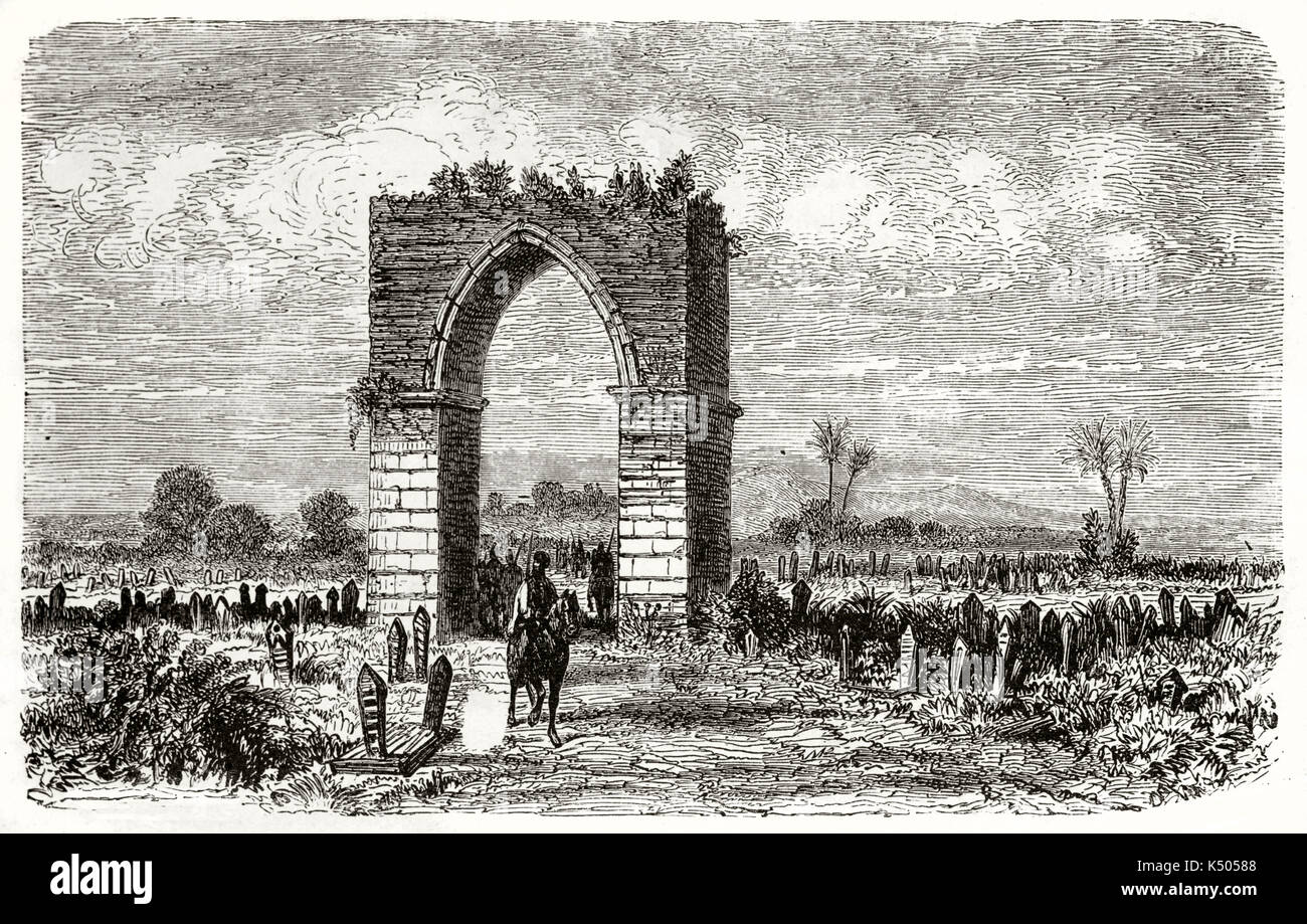 Desolated ancient cemetery with the ruins of a stone vaulted door on the center. Old view of the Iron Gate Tarsus Turkey. Created by Grandsire and Gaushard published on Le Tour du Monde Paris 1862 Stock Photo