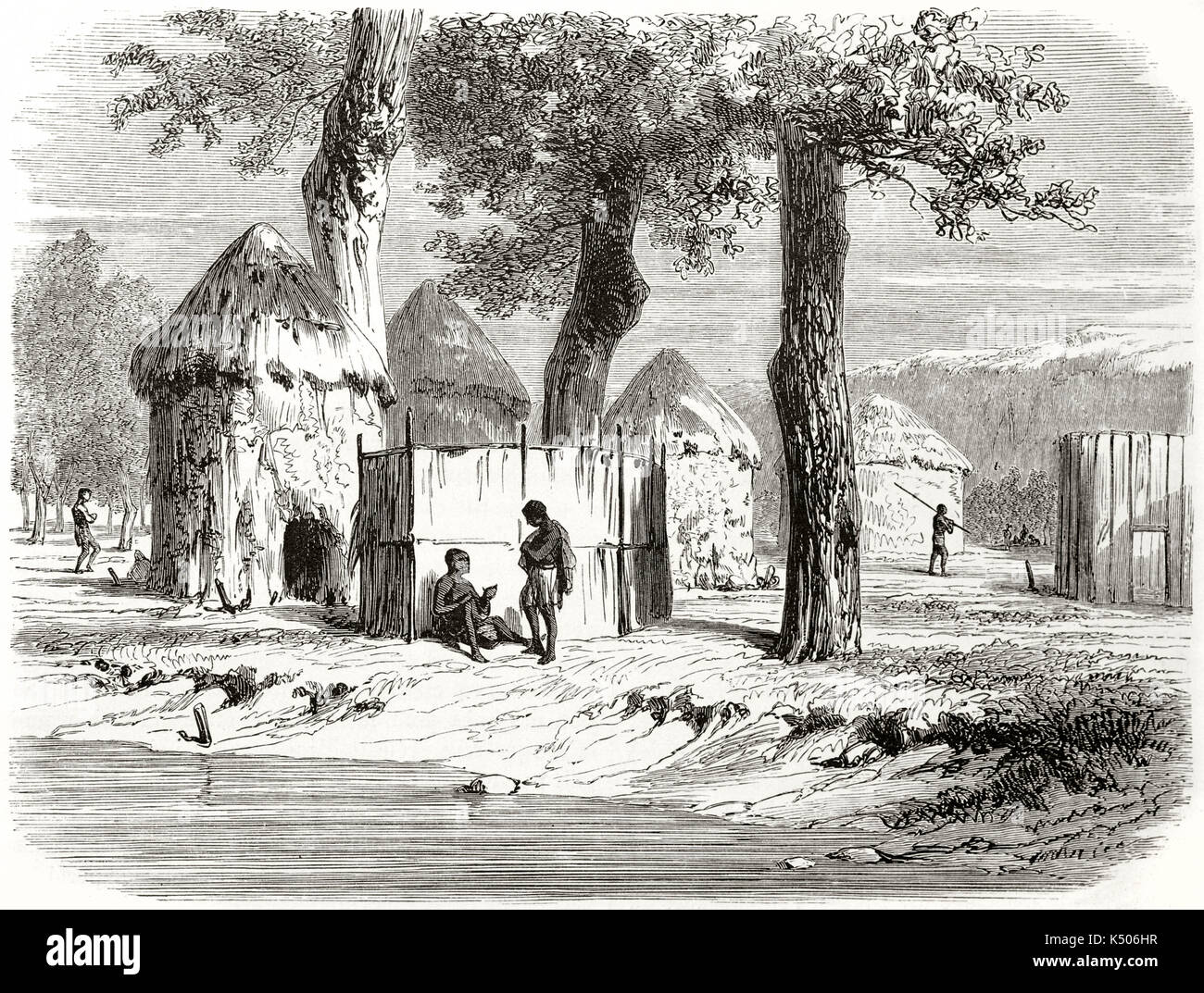 Ancient native africans in their made by huts village close to a river. Nouen African village