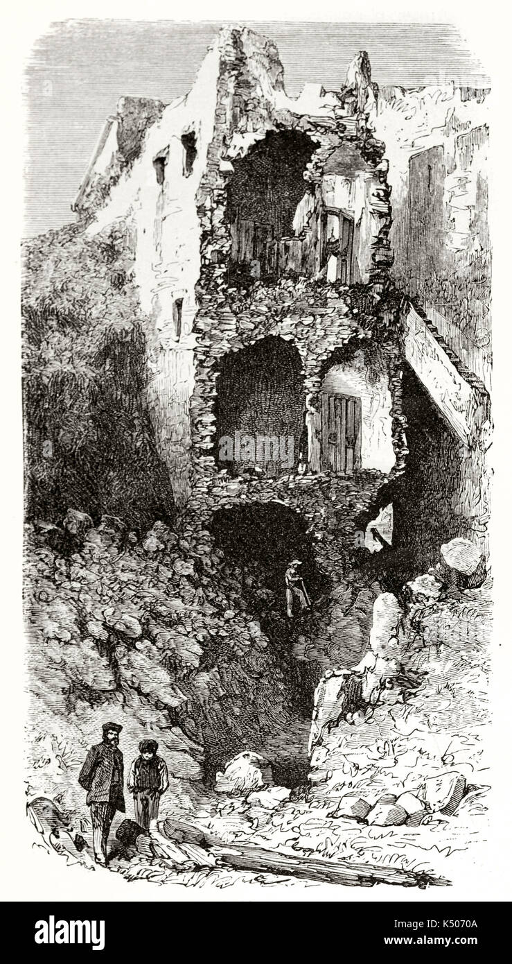 Ancient building splitted by a eruption or a earthquake close to two resigned people. Ruins in Torre del Greco Italy after Vesuvius eruption and overflowing in 1861. By Riou Le Tour du Monde 1862 Stock Photo