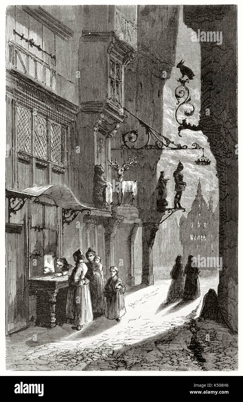 Ancient people in a dark medieval city alley are waiting in front of a bakery little window in Ulm, Germany. Published on Le Tour du Monde Paris 1862 Stock Photo