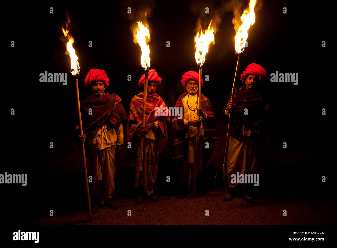 Rabari men holding wooden torches on new years eve Stock Photo