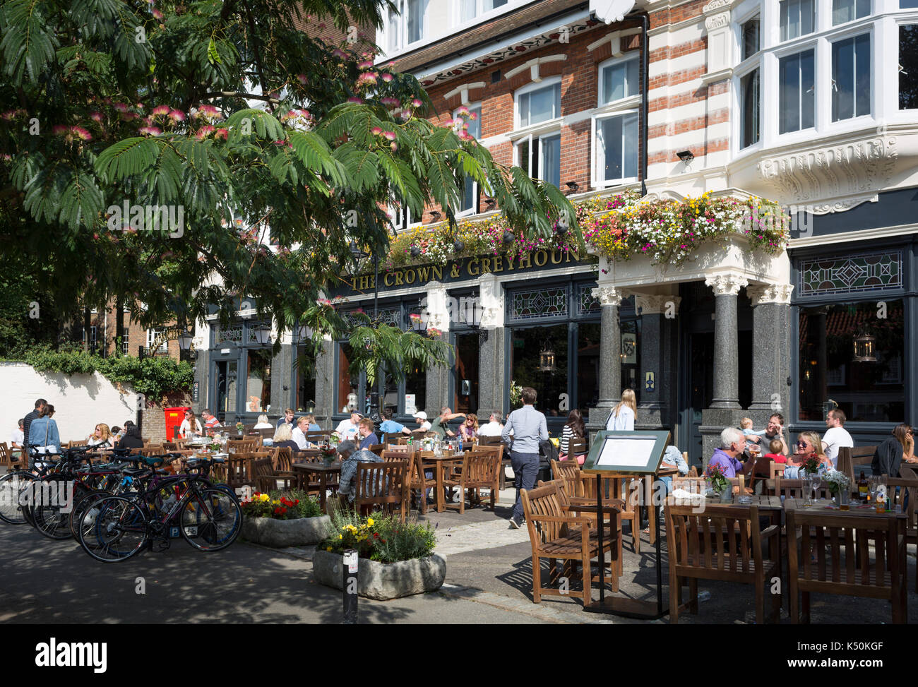 Summer drinkers enjoy a warm Sunday afternoon outside the newly refurbished Crown and Greyhound pub in Dulwich Village, on 2nd September 2017, in south London, England. 20 new bedrooms are available for short-stays but the pub gets its name from two former pubs in Dulwich Village, The Crown, and The Greyhound, which were across the street from each other up to the 1890s. The Crown and Greyhound is a Grade II listed public house at 73 Dulwich Village. Stock Photo