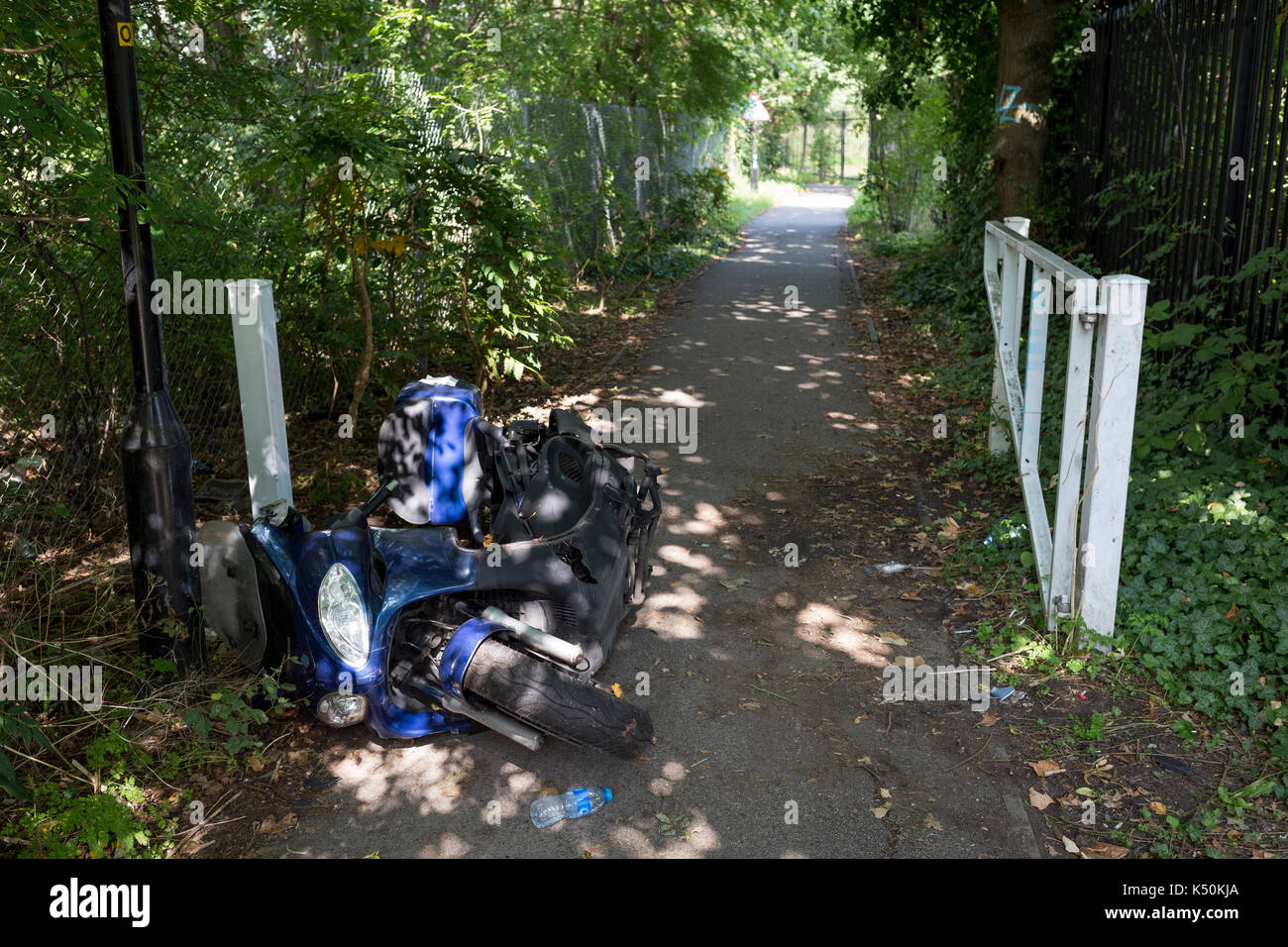 A crashed motorbike scooter left abandoned on a path in south London ...
