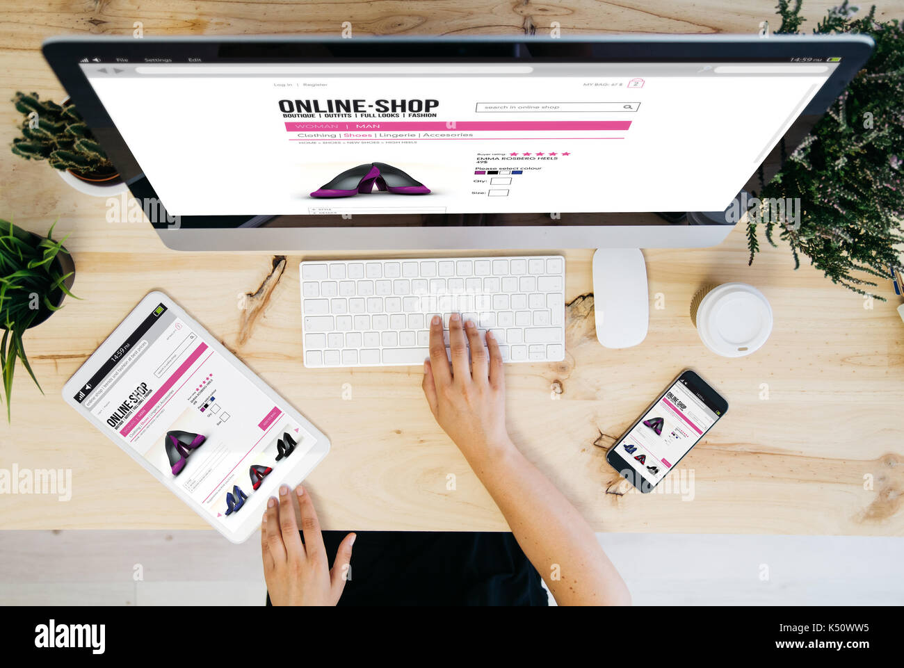 overhead desktop with online shop website on devices screen. Stock Photo